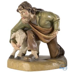 Shepherd kneeling with sheep