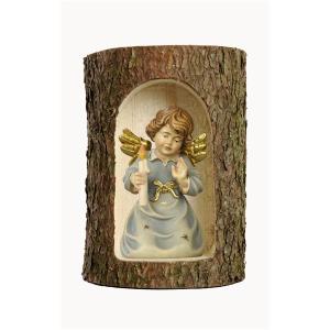 Bell angel with candle in a tree trunk