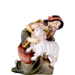 Pastore in ginocchio con pecora